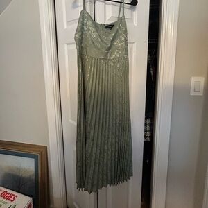 Green midi dress with pleats and floral accents